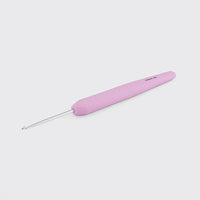Light pink crochet hook on a white background