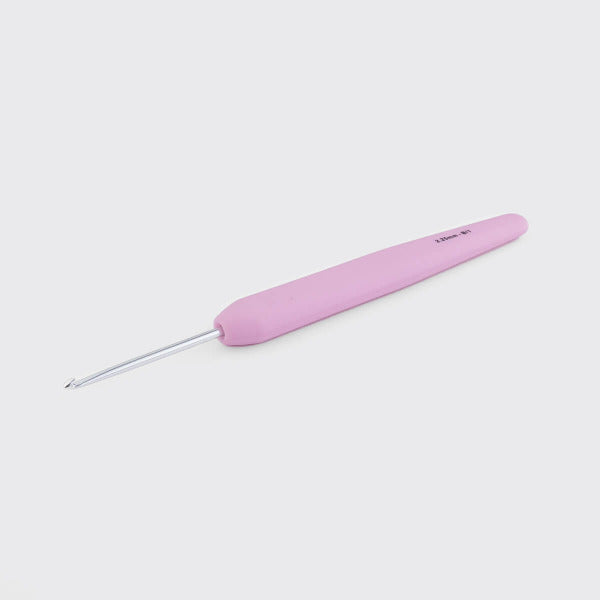 Light pink crochet hook on a white background