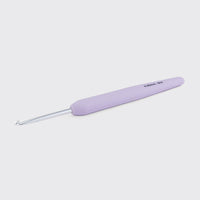 Pale purple crochet hook on a light gray background