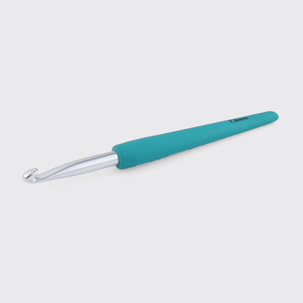 Teal-handled crochet hook on a light gray background