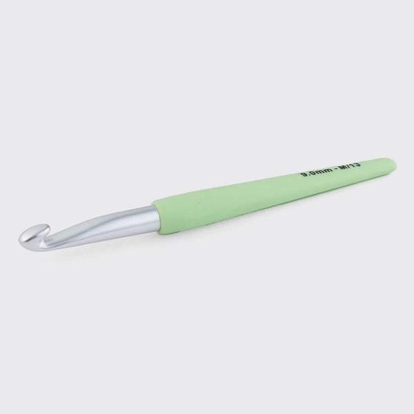 Light green crochet hook on a white background
