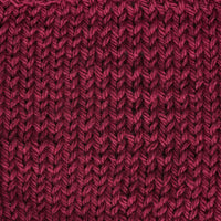 Close-up of a textured burgundy red knit fabric 