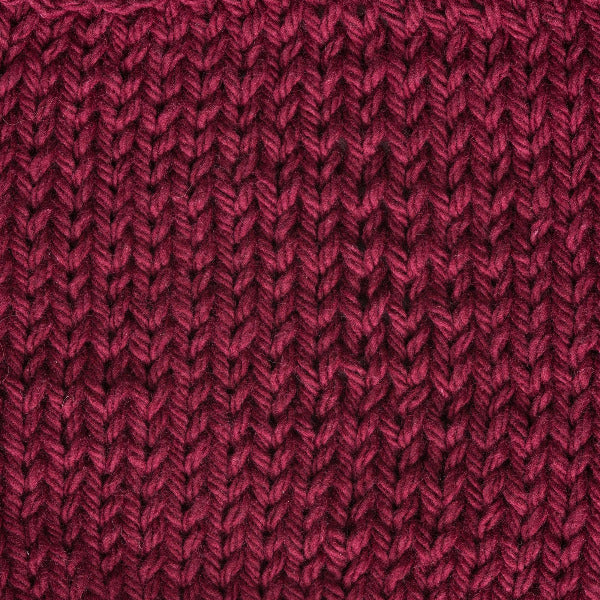 Close-up of a textured burgundy red knit fabric 
