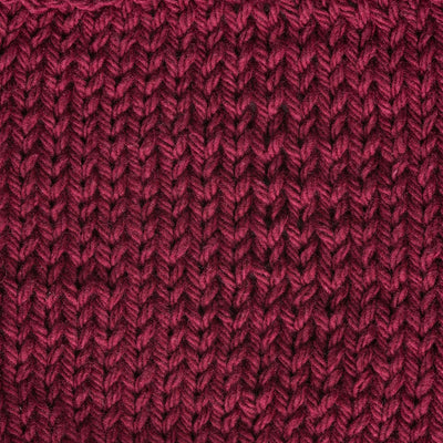 Close-up of a textured burgundy red knit fabric 