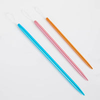 Three colorful wool needles on a white background